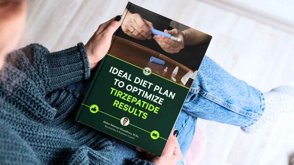 Person in a gray sweater holding a nutrition guide book titled "Ideal Diet Plan to Optimize Tirzepatide Results" by Abdur Rahman Choudhury, M.Sc.